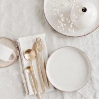 Modern,Ceramic,Tableware,Top,View,On,White,Linen,Tablecloth,With